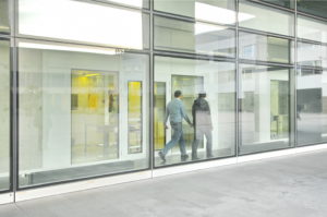 hommes dans un couloirs derrière un mur en verre - Rosin Entreprise